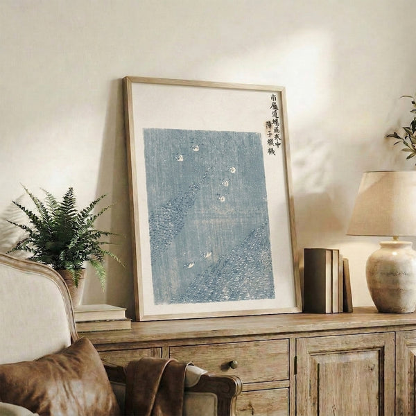 Japanese woodblock crane artwork in contemplative rain scene, rendered with pale grays and slate tones in calming Japandi style.