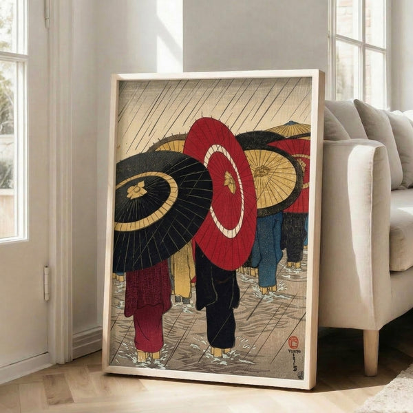 Traditional Japanese woodblock print capturing a quiet, atmospheric moment of pedestrians sheltering under umbrellas during rainfall, rendered in rich reds, blacks, and gold on cream.