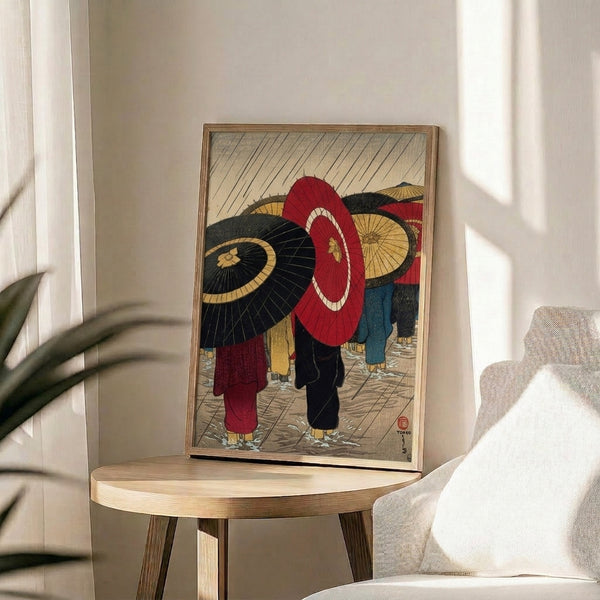 Contemplative Japanese Showa-era woodblock art print featuring umbrella-carrying figures in the rain, with bold red and black lines on a cream and gold background.