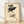 Minimalist line art print featuring a raven perched atop a skull in black and cream, evoking gothic and memento mori themes.