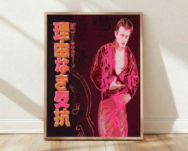 Pop art portrait of James Dean in vibrant color blocks, inspired by Warhol's iconic style, displayed as a framed poster on a wall.