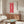 Japanese-inspired ornamental print with crimson flowing arabesque design on cream ground, elegant woodblock art for wall decor.