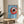 Framed contemporary poster of a blue-striped coffee cup with spoon and coffee beans arranged on white and cream, embodying calm minimalist design.
