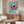 Minimalist coffee cup artwork with bold red and blue stripes, accompanied by a spoon and scattered beans, creating an inviting modern home decor piece.