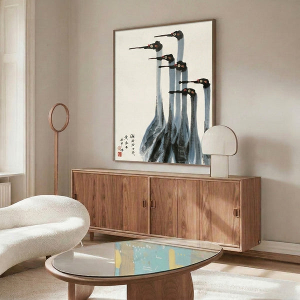 Zen-inspired framed art print featuring cranes rendered in sumi-e ink, sparse brushwork in charcoal, cream, and pale blue with crimson accents, contemplative minimalist style.