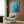 Modern Japandi wall print featuring an isolated orange fish amid serene cerulean waters with subtle white accents, evoking quiet contemplation.