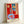 Framed modern art print showing an emotionally vibrant still life composition with red, blue, and green abstract elements in a minimalist interior setting.