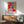 Modern abstract still life framed print displaying an energetic composition of reds, blues, and greens in a simplified interior arrangement.