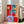Modern art print displaying a table arrangement rendered in flat planes of red, blue, and neutral tones with expressive, non-naturalistic color choices.
