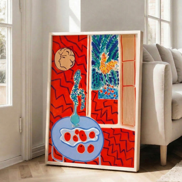 Modern art print displaying a table arrangement rendered in flat planes of red, blue, and neutral tones with expressive, non-naturalistic color choices.