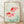Framed Japanese woodblock print of two goldfish swimming among aquatic plants in soft coral red and sage green tones, evoking serene natural beauty.