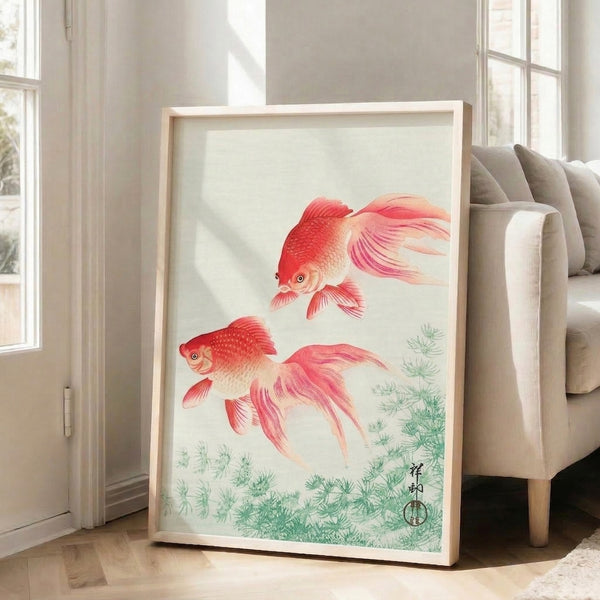 Framed poster featuring two elegantly rendered fish among water plants in muted coral, sage, and cream hues with tranquil Japandi aesthetic.