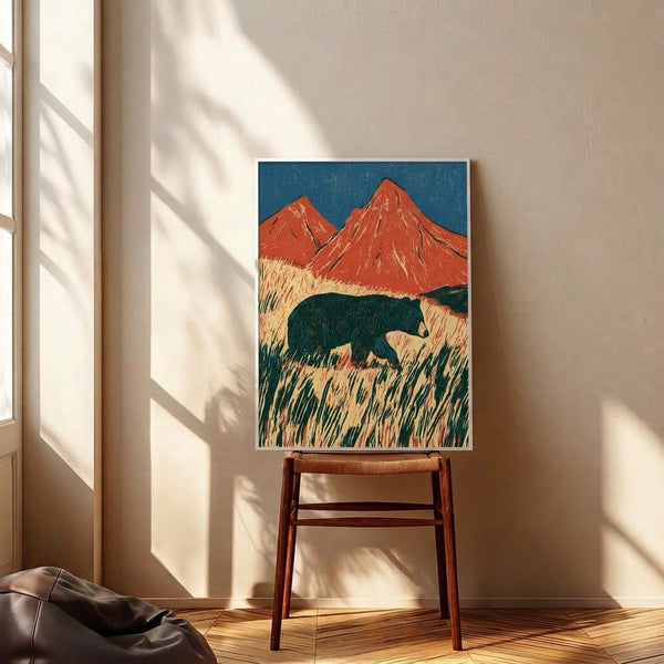 Framed art print in Japanese woodblock style: a contemplative bear amid cream grassland with bold red volcanic mountains, navy accents, and teal tones creating a vintage, majestic composition.