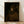 Framed portrait of a contemplative monk in golden-brown tones, rendered in soft impressionist style with warm ochre and burnt umber hues suggesting intimate dignity.