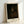 Contemplative monk portrait in dark academia style, featuring warm cream and ochre tones against deeper burnt umber shadows, displayed as framed wall art.