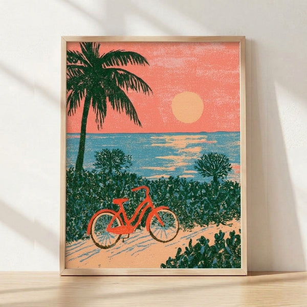 Retro-style coastal art print featuring a bicycle leaning against a palm tree on a beach at golden sunset, rendered in warm coral, sage green, and teal tones.