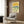 Retro beach wall art in cream, golden yellow, and slate blue tones depicting a serene seaside scene with mid-century modern design sensibility.