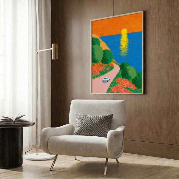 Vintage-inspired poster artwork showing a convertible car on a scenic coastal drive with wildflowers, ocean views, and a golden sunset sky in shades of orange, yellow, and pink.