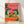 Retro boho folk art poster featuring whimsical alligators wearing party hats gathered around a festive dinner table with wine glasses, tropical fruit, and candlelight in vibrant hot pink, forest green, coral, and teal.