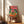 Festive boho wall art depicting alligators at a whimsical dinner party adorned in hats, surrounded by wine, tropical palms, and colorful fruit in warm coral, teal, and cream tones.