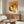 Nostalgic chinoiserie-inspired art print depicting dim sum fare with dumplings, chopsticks, and sauce in soft vintage tones of cream, warm orange, and muted olive green.