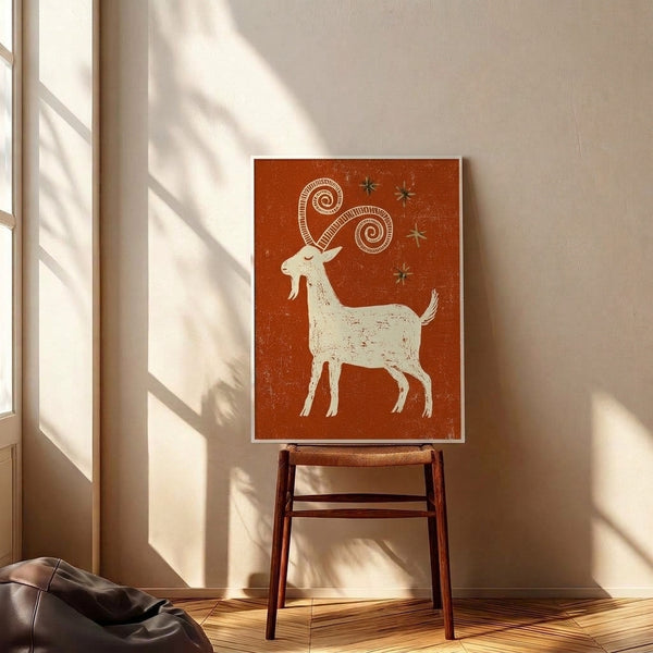 Folk art goat illustration with festive celestial elements and spiral patterns in rust orange and cream, mounted as a framed poster.