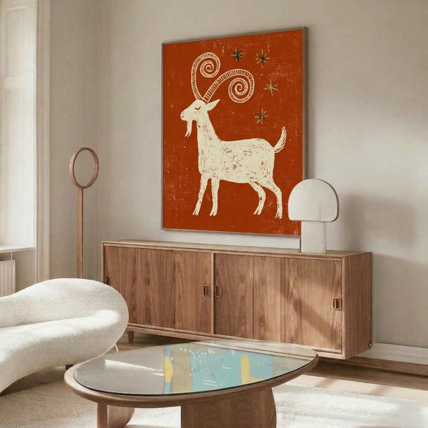 Vintage-inspired goat artwork with whimsical star and spiral details in earthy rust, olive, and burnt sienna hues, framed for wall display.