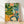 Retro boho still life poster featuring a tea table arrangement with a teal teapot, golden yellow flowers, coral oranges, and steaming dumplings on cream dishware surrounded by forest green plants and leaves, evoking warm domestic comfort.