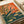 Contemporary retro-style poster showcasing a praying mantis amid flowering grasses and plants, featuring a soothing palette of cream, tan, rust orange, and soft blue-green tones.