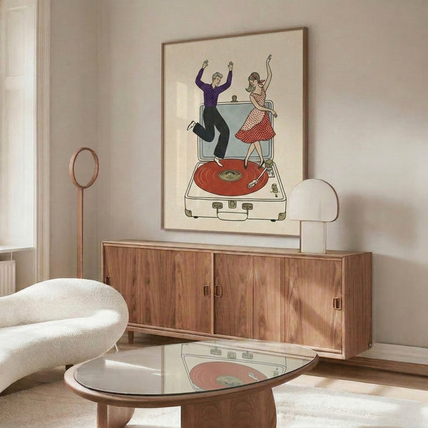 Vintage-style poster showcasing a playful couple dancing by a turntable surrounded by vinyl records and a suitcase, combining retro charm with cream, tan, red, and purple accents.