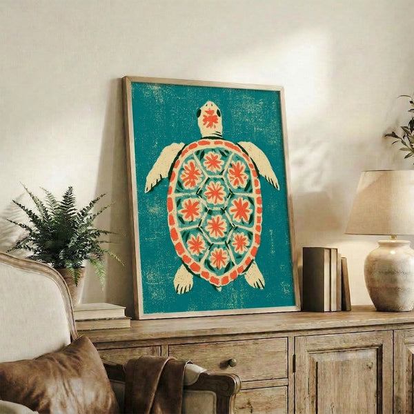 Wall-mounted poster of a folk art turtle in mosaic style, combining coral and teal hues with minimalist florals against a soft cream base.