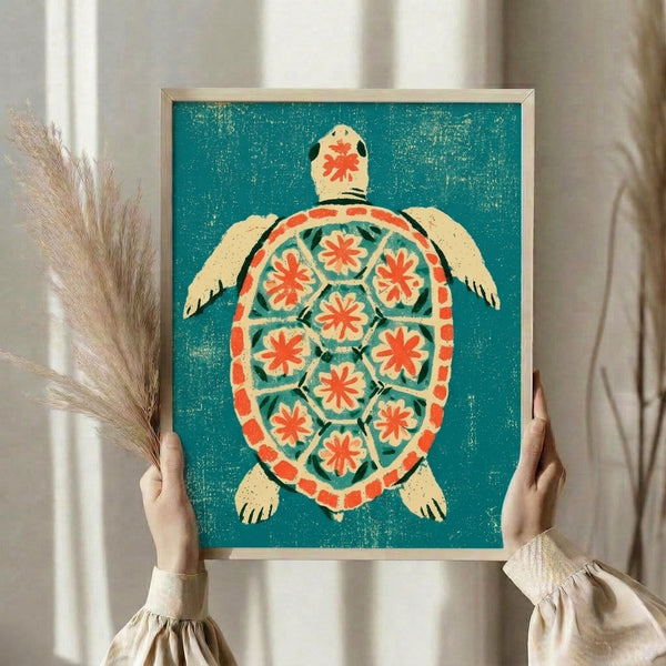 Framed sea turtle print in retro folk art style with whimsical mosaic shell pattern in coral and teal, accented by botanical details on cream.