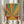 Vintage-inspired sun rise print with geometric rays in rust red and sage green tones, displaying retro aesthetic warmth on a framed wall poster.