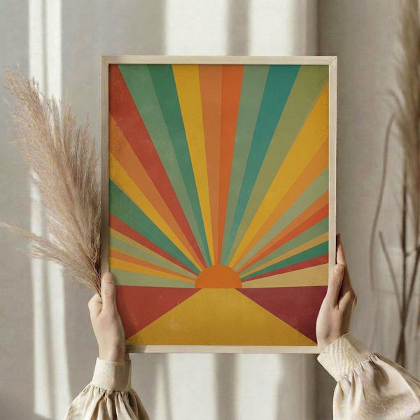Vintage-inspired sun rise print with geometric rays in rust red and sage green tones, displaying retro aesthetic warmth on a framed wall poster.