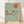 Retro minimalist poster art featuring a golden trumpet and stylized sun in burnt orange and sage green tones, evoking mid-century modern jazz aesthetics.