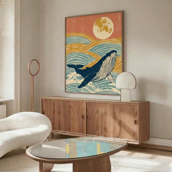 Framed wall art depicting a contemplative humpback whale silhouette against a glowing moon and calm sea in retro palette of rust, cream, and teal hues.