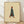 Minimalist line art poster of a woman in a teal coat and boots walking with a handbag, rendered in cream, teal, rust, and brown tones on a framed wall art print.