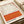 Abstract wall poster with warm cream and burnt orange tones in soft, overlapping horizontal forms, creating emotionally resonant minimalist composition.