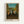 Wall-mounted poster featuring Rousseau's surreal landscape with football players among dense trees and vegetation, rendered in earthy rust browns and forest greens with playful, innocent charm.