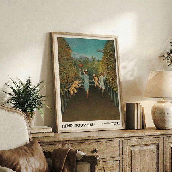 Wall art print of Henri Rousseau's The Football Players, a surreal folk artwork featuring men, ball, and trees in a harmonious blend of teal, ochre, rust, and forest green.