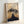 Framed Japandi art print showing a reverent samurai standing before Mount Fuji in a restrained minimalist style using soft cream, tan, and charcoal hues.