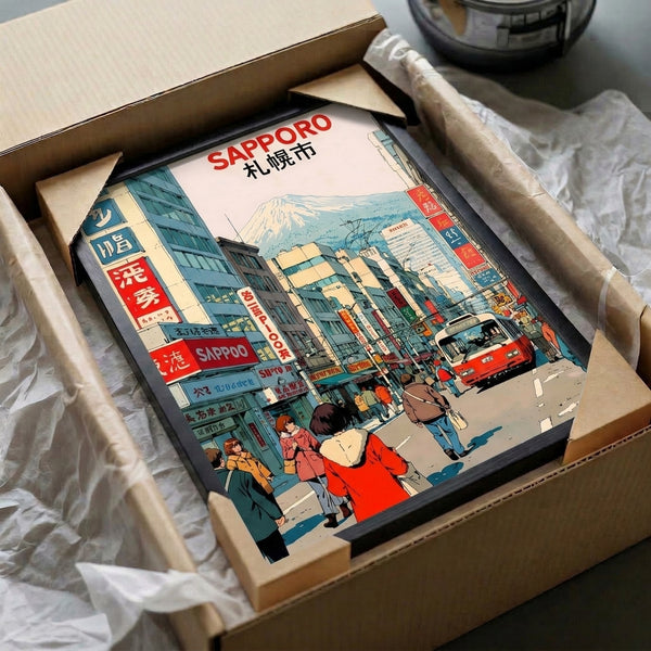 Retro Sapporo city poster framed on wall, showcasing animated street life with Japanese architectural details and mountain backdrop in warm and cool vintage color harmony.