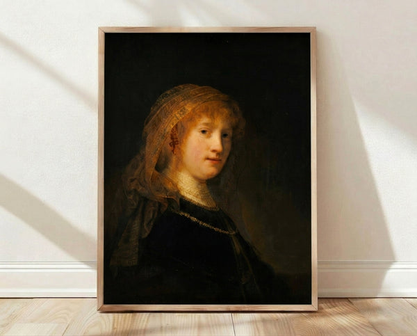 Framed portrait painting by Rembrandt depicting Saskia van Uylenburgh in warm golden and brown tones, showcasing Dutch Golden Age mastery of light and shadow on a gallery wall.