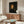 Framed historical portrait artwork in warm rust and honey tones, demonstrating Renaissance-era painting methods with dignified and serene atmosphere.