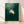Minimalist sea turtle silhouette in teal and deep green tones swimming through serene ocean waters, framed coastal wall art with a peaceful, meditative mood.