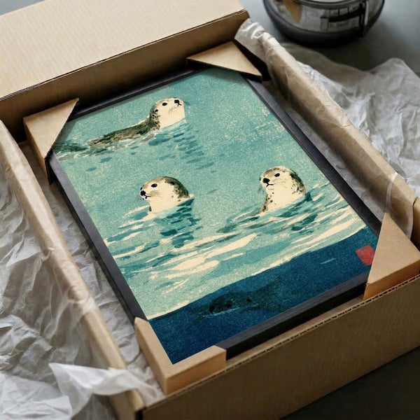 Peaceful watercolor framed print of swimming seals in soft cream, blue, and sage green palette, combining Japanese artistic tradition with zen minimalism.