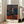 Abstract interpretation of a solitary figure in a chair, rendered in muted greys and ochres with psychological intensity characteristic of contemporary modern painting.