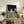 Framed art print featuring a solitary figure seated against a neutral background, created in an abstract expressionist manner with layered, subdued coloring.