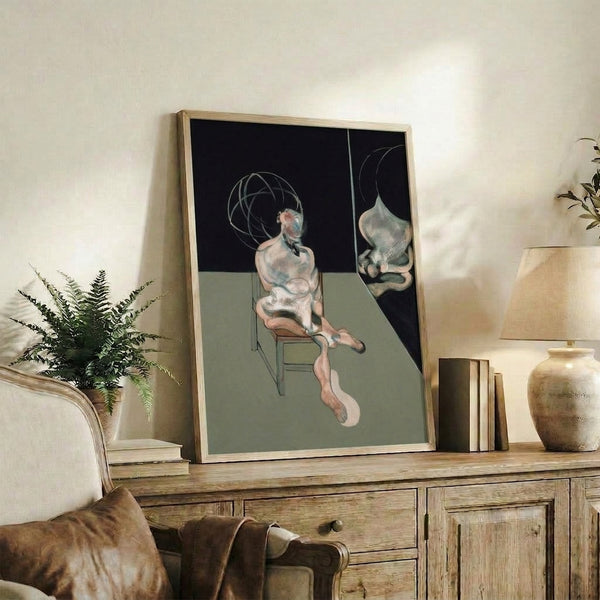 Framed art print featuring a solitary figure seated against a neutral background, created in an abstract expressionist manner with layered, subdued coloring.