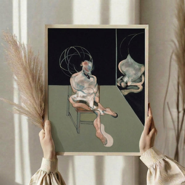 Minimalist wall art depicting a seated form in soft browns, grays, and ochre tones, characterized by loose, gestural marks and an introspective atmosphere.